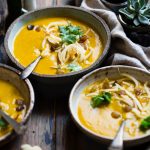 three noodle dishes with orange sauces in food photography